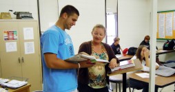 Kristie Olson, who teaches an entrepreneurship class at Madison High School, talks with Tyler Wiebe, a senior at Madison and a member of the Future Business Leaders of America. Photo by Becky Froehlich