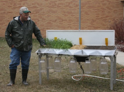 Jeff Hemenway, soil quality specialist for the NRCS, explains how the rain simulator works at an event in Brookings in April 2012. Photo by Heidi Marttila-Losure