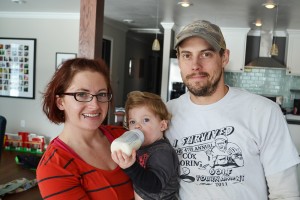 Jami Eberle (holding their son, David) and Justin Meidinger of Ellendale, N.D., are active in their community in different ways than older generations may have chosen to be involved. Photo by Ken Schmierer