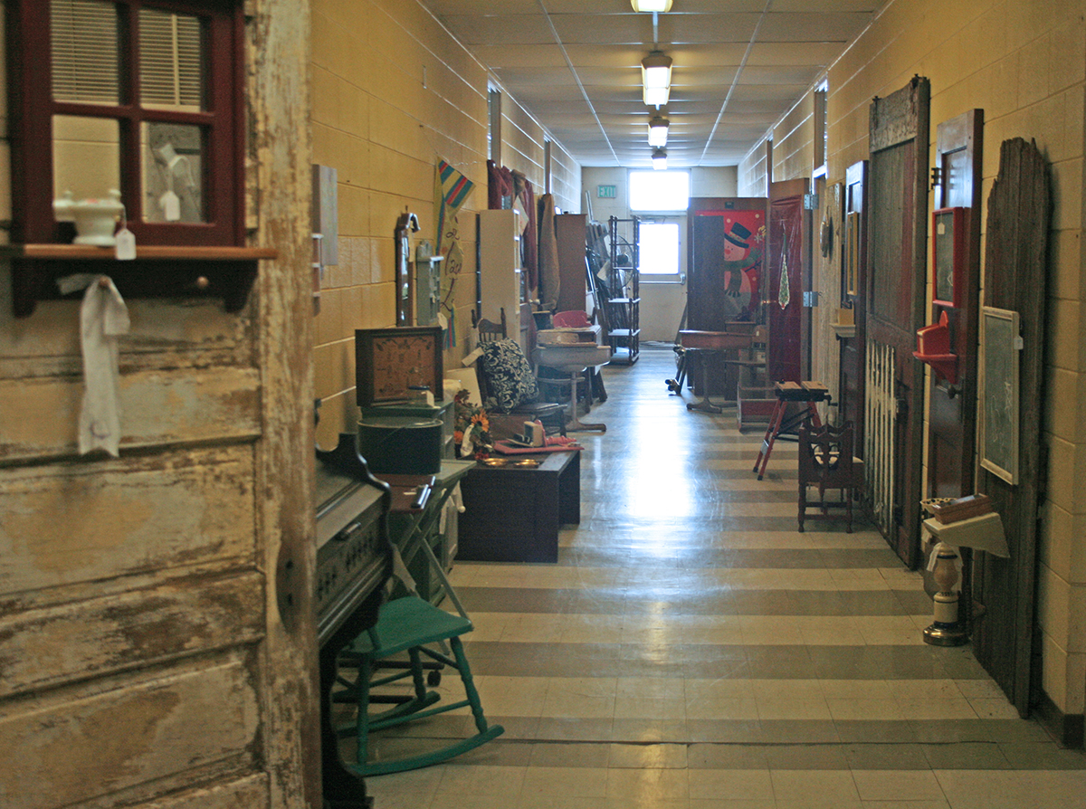 The hallway of the Guelph School, as well as most of the rooms, are now filled with merchandise for the new venture, called Off the Shuelph in Guelph. People drop off things they no longer use, such as old chairs or vintage doors, and the Off the Shuelph women use their creativity to imagine what the new life for those objects could be. A local retired farmer does whatever carpentry work is needed. They also do custom work—recovering old chair seats, for example. 