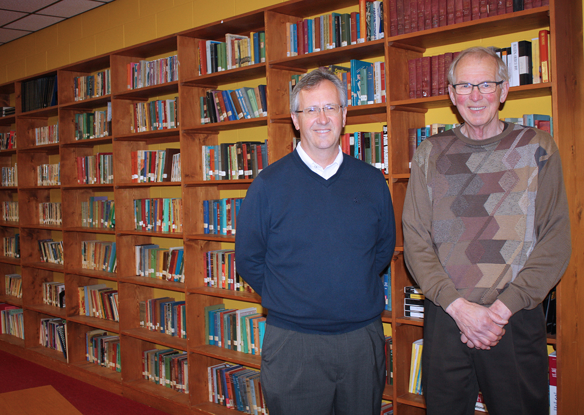 Corsica High School Principal Scott Muckey (left) and Superintendent Vern DeGeest stand inside the school’s library. The men agree that consolidating with the Stickney School District next fall is a positive move for students that has been well-received by both communities.