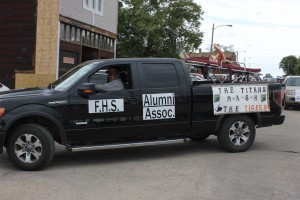 Members of the Frederick, S.D., alumni float makes its way through a homecoming parade there.