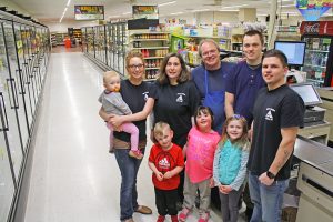 Krull’s Market has been in the Krull family since Dana Krull’s parents purchased it in 1969. Today, his own descendants regularly can be found in the store. Pictured, left to right (front row): grandson Abel Slate, daughter Molly Krull, daughter Sarah Krull, (back row), granddaughter Audrey Slate, daughter Eden Slate, wife Jennifer Krull, Dana Krull, son Seth Krull and son-in-law Dylan Slate.