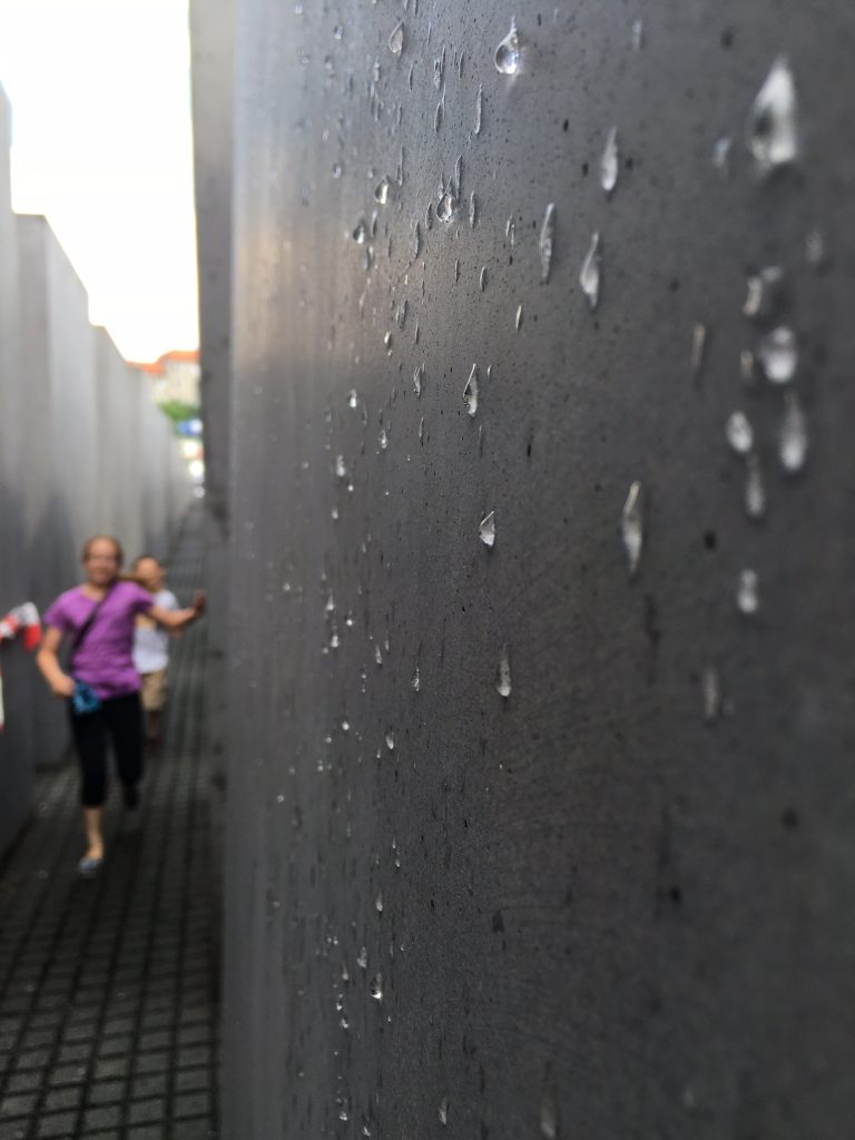 Rain clings to the side of one of the cement pillars in the Holocaust Memorial in Berlin. By Heidi Marttila-Losure