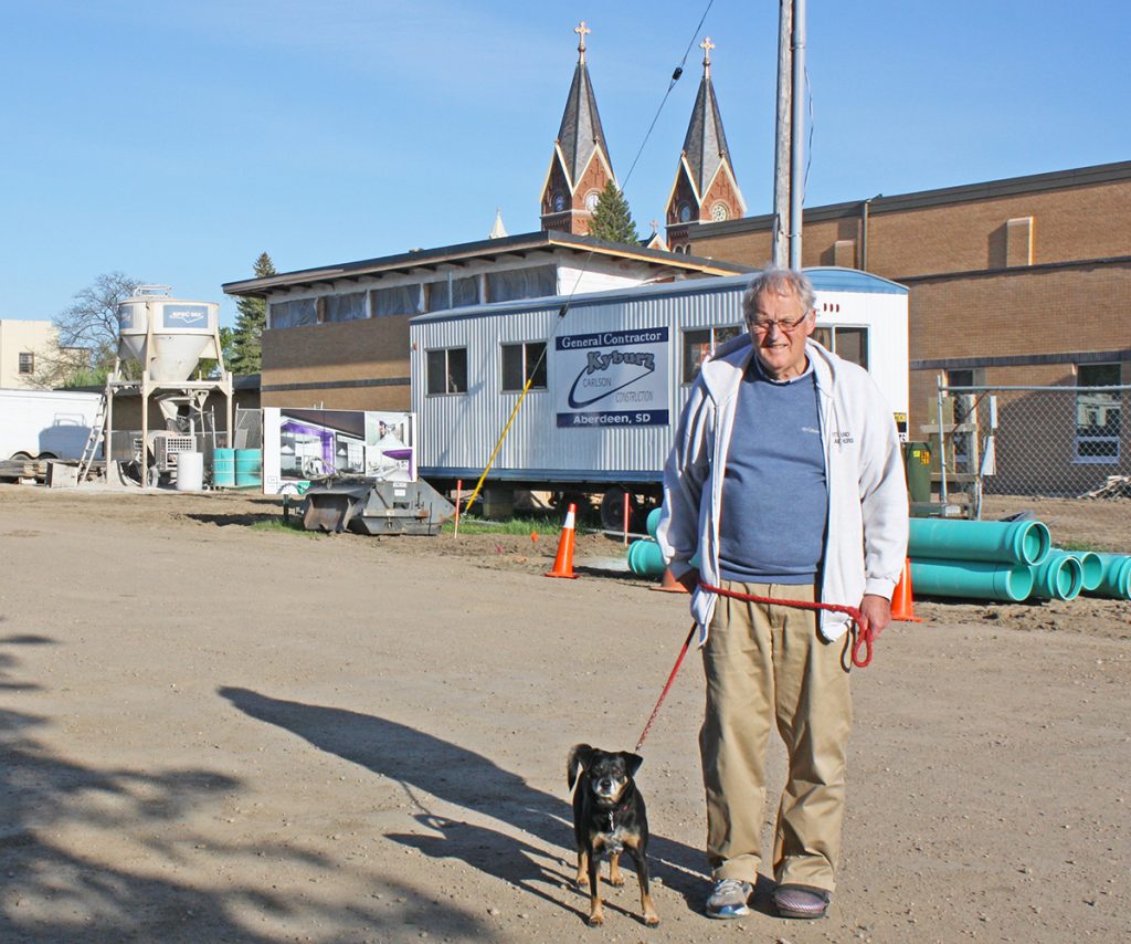 Superintendent Bob Graham and Buddy moved to Hoven, S.D., a year after the high school burned down. Twice retired, Graham said he envisions spending a few more years at work, helping students and staff adjust to the new building, set to open in August, before retiring for good. Buddy is an unofficial service dog to students experiencing medical, emotional or behavioral turmoil during the day. By Wendy Royston/Dakotafire Media