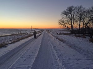 Annikki Marttila walks along the gravel road near her Frederick, S.D., home nearly every day. Here, she walks as her grandson skis in the ditch to the right. Photo by Heidi Marttila-Losure