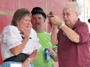Trial by marksmanship for Dead-Eye Millie Hansen resulted in a “surprise” guilty verdict. Keeping an eye on where she pointed the gun are Susan and Kirk Schaefers. The drama was part of the Orient, S.D., 125th Celebration July 6-8. Photo by Faulk County Record