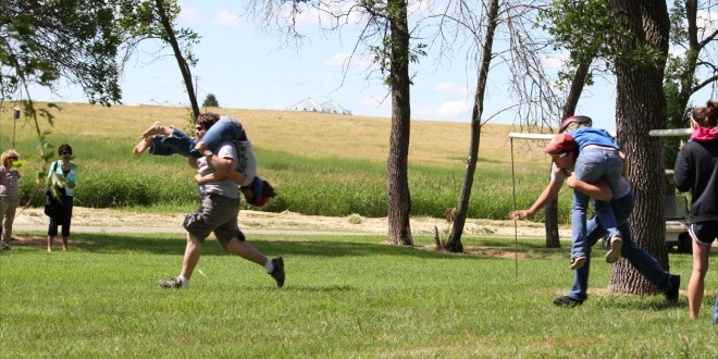 Two of the contestants during the wife-carrying contest round a corner during Finn Fest in Frederick. Photo courtesy fredericksd.com