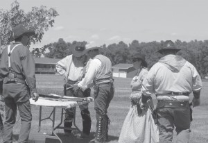 Participants get ready for the next round at Cowboy Action Shooting in Clark, S.D.