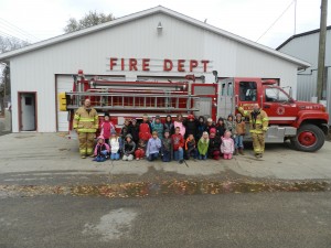 Firemen gave a tour of the fire hall to second-graders from LaMoure school during Fire Prevention Week. Photo by LaMoure Chronicle.