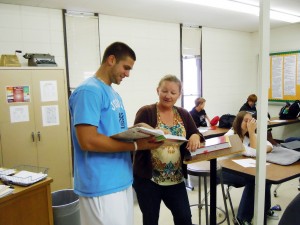 Kristie Olson, who teaches an entrepreneurship class at Madison High School, talks with Tyler Wiebe, a senior at Madison and a member of the Future Business Leaders of America. Photo by Becky Froehlich