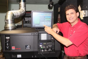 Tom Farber stands next to the new digital equipment in the Strand Theatre in Britton. Britton Journal photo
