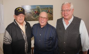 Carroll Peterson, left, of Webster, and John Audus, middle, of Clark, were in the same company in World War II, unbeknownst to each other. Marlin Fjelland, right, of Clark, found out about them both being on the same plane for a short while on Christmas Day 1944. Fjelland helped the two get acquainted and reminisce about this fateful trip home. Photo by Clark County Courier