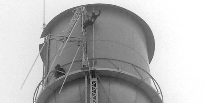 Workers scale Clark’s water tower to work on antenna