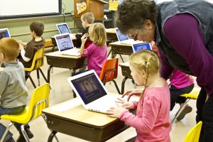 Teacher’s aide Linda Gutschmidt helps a kindergarten student with her keyboarding lesson at Gackle-Streeter Public School. Photo by Melody Owen/Tri-County News