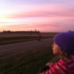 Erik Losure, 5, and Sofia Losure, 7, stop during a bike ride to enjoy the colors of a beautiful Dakota sunset. In less than 10 years, a transmission line is slated to be built in that sunset view. Photo by Heidi Marttila-Losure