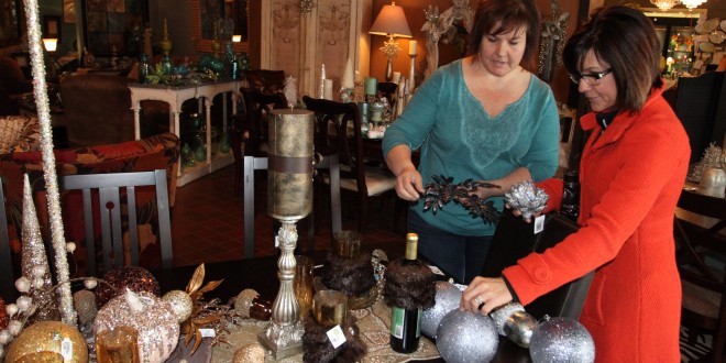 Patience Pickner, owner of The Picket Fence in Chamberlain, S.D., helps a customer piece together an arrangement of home décor items. She says customers appreciate the one-on-one customer service they can’t find in a big box store. Photo by Jessica Giard