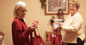 Frances Heeren, employee of the Interlakes Community Action Program thrift store, and Jeanie Fuller, ICAP county director, fill Christmas bags to be distributed this week. Photo by Bill Krikac, Clark County Courier