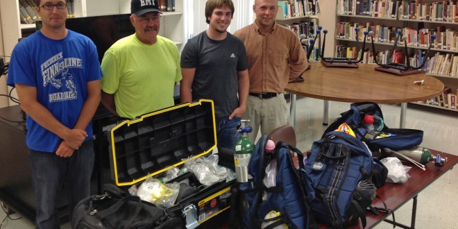 Members of the Frederick Area First Responders show off their “ambulance in a bag” kits. From left are David Losure, Rick Adema, Austin Hoerner and Cole Adema. Photo by Heidi Marttila-Losure