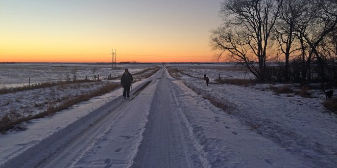 Annikki Marttila walks along the gravel road near her Frederick, S.D., home nearly every day. Here, she walks as her grandson skis in the ditch to the right.   Photo by Heidi Marttila-Losure
